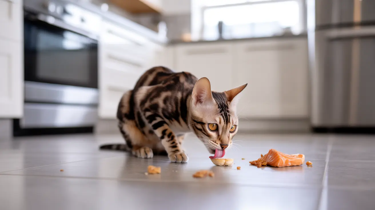 A Bengal cat eating a piece of salmon on a kitchen floor